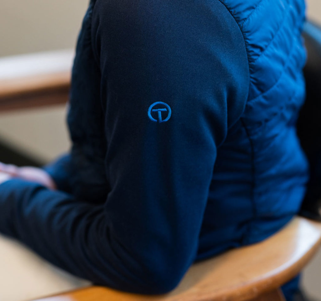 Close up of blue jacket with Thrift logo